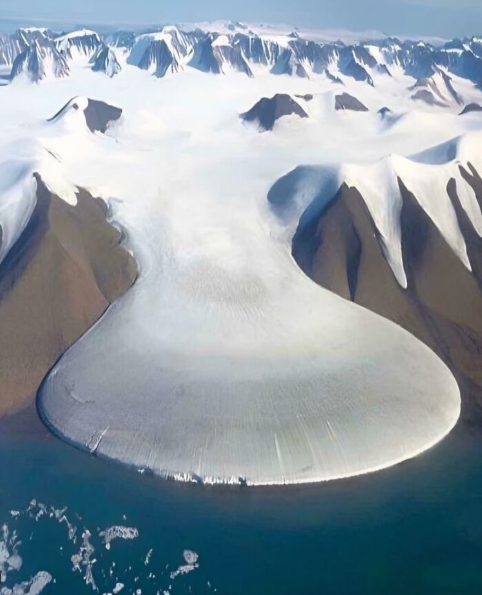 Massive snow-covered mountain and glacier landscape, showcasing scarily big natural formations and icy terrain.