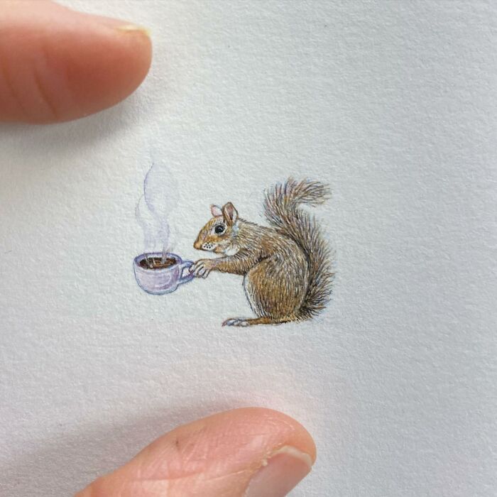 Tiny one-inch painting of a squirrel holding a steaming cup, showcasing detailed everyday miniature art by Brooke Rothshank.