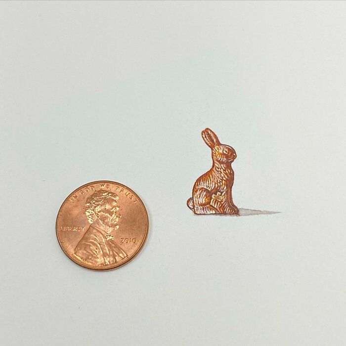One-inch painting of a small brown rabbit next to a penny, showcasing tiny everyday art by Brooke Rothshank.