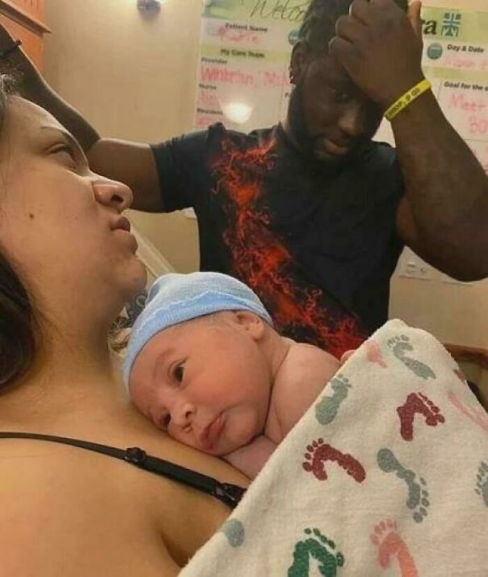 Newborn baby with adults in a hospital room, capturing a moment that might make your brain short-circuit in blursed images.
