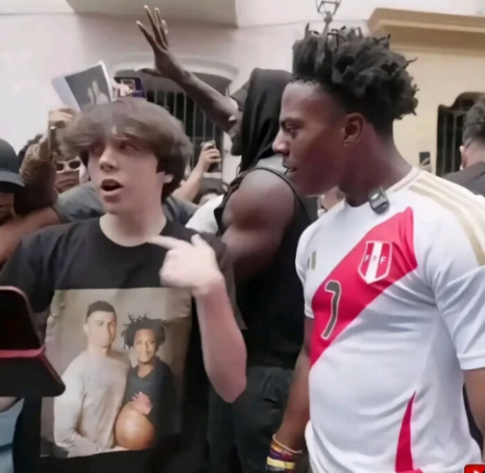 Two young men in a crowded setting, one wearing a Peru soccer jersey, capturing a blursed image moment.