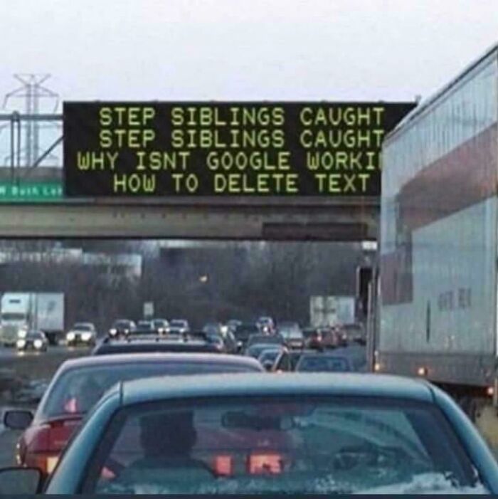 Highway traffic jam with a confusing digital sign showing mixed messages, a blursed image that may short-circuit your brain.