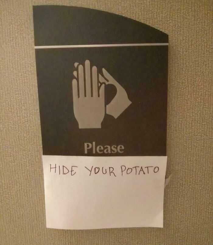 Sign with a hand gesture and a handwritten note saying hide your potato, showcasing wholesome street vandalism creativity.