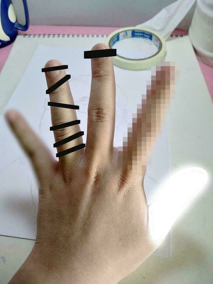 Photo of a hand with black lines and pixels censoring fingers, creating a blursed image that may confuse the brain.