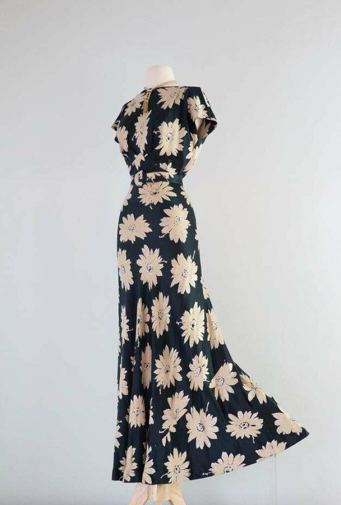 Vintage black dress with beige floral patterns, showcasing classic fashion style from a few centuries in minutes.