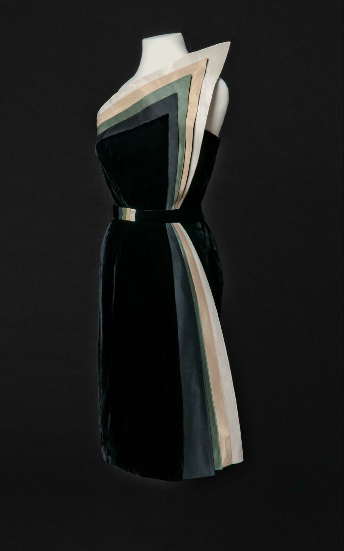 Elegant vintage dress with geometric color blocks showcased in a fashion exhibition representing centuries of style evolution.