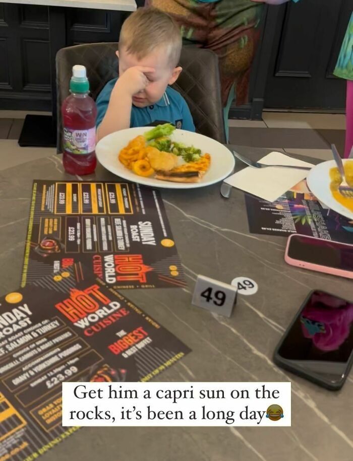 Young boy with a frustrated expression sitting at a table with food and drink, relatable meme with sarcasm.