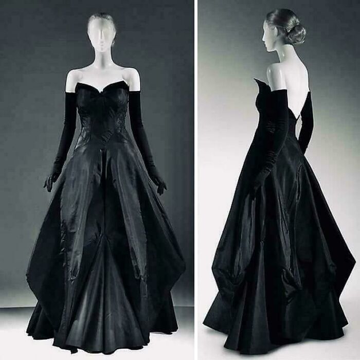 Black vintage evening gown with long gloves displayed on mannequins showcasing centuries of fashion history.