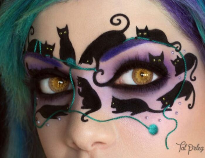Creative makeup look featuring black cat designs and purple eyeshadow, showcasing incredible makeup artistry skills close-up.