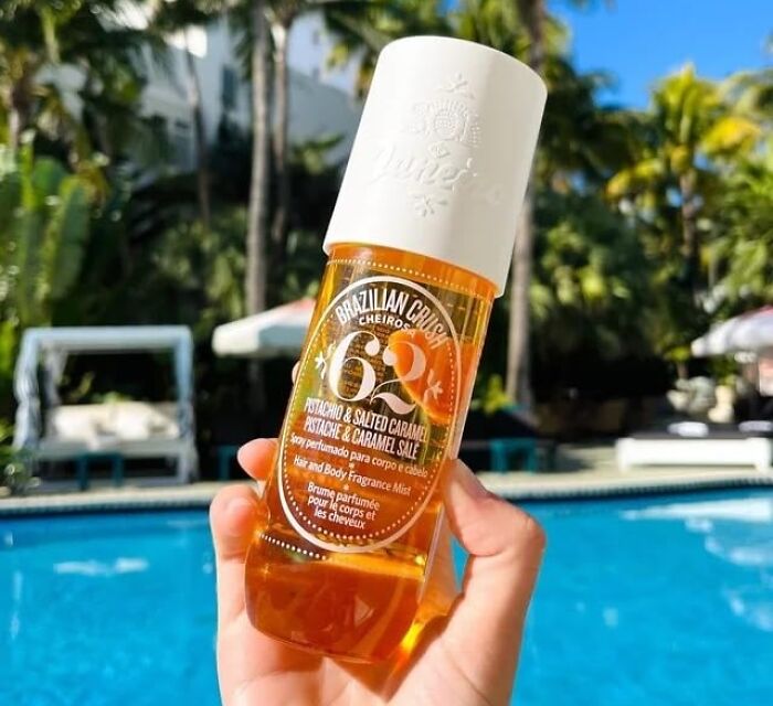 Hand holding Brazilian Crush Pistachio and Salted Caramel body fragrance mist, one of the affordable Amazon finds.