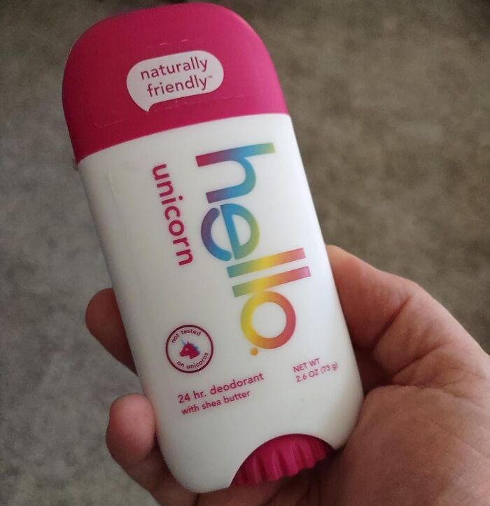 Hand holding a Hello Unicorn 24-hour deodorant stick with shea butter, a weirdly wonderful find in natural personal care.