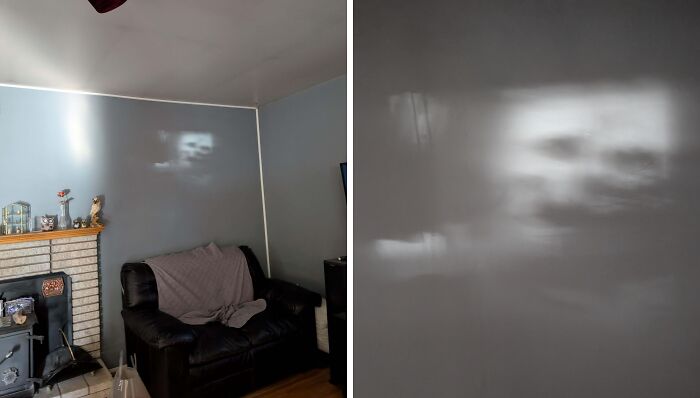 Faint creepy face reflection on a living room wall above a couch, capturing a spooky moment people shared online.