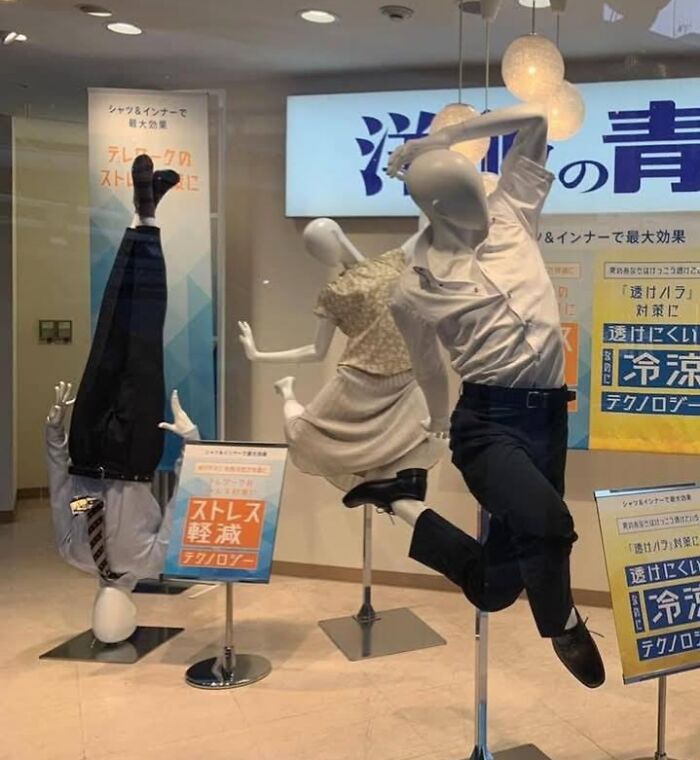 Mannequins in dynamic, weird poses in a store window, showcasing unusual pics or it didn’t happen moments.