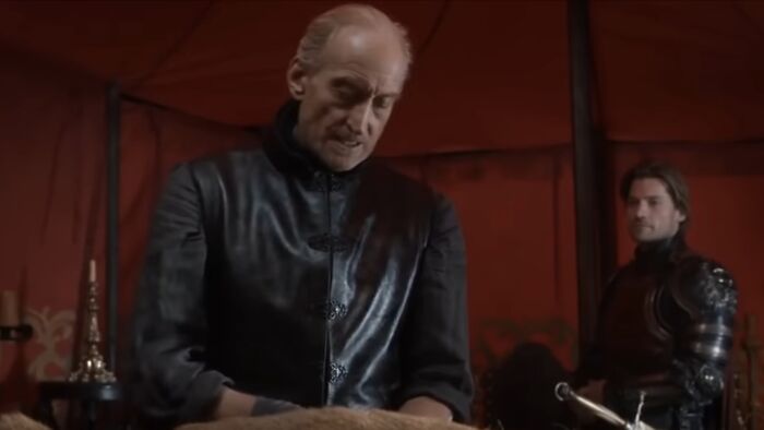 Two actors in medieval costumes filming a tense behind-the-scenes moment from movies and TV shows.