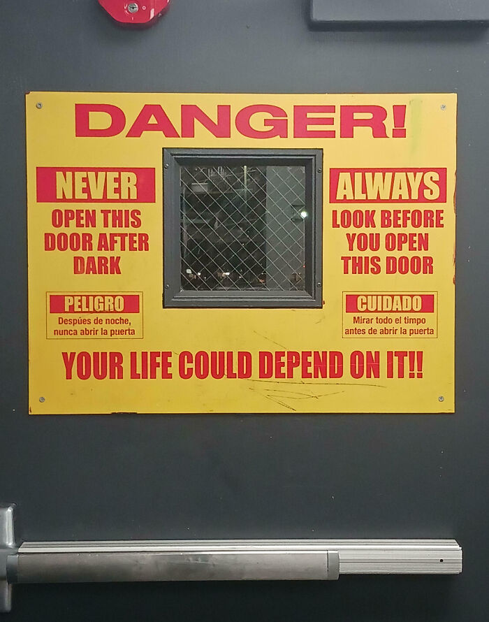 Warning sign on a door with creepy messages about never opening it after dark and looking before opening.