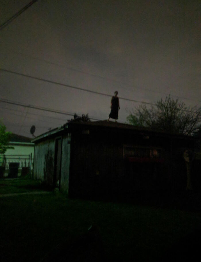 Figure standing on a rooftop at night with eerie lighting, capturing a creepy moment people had to share online