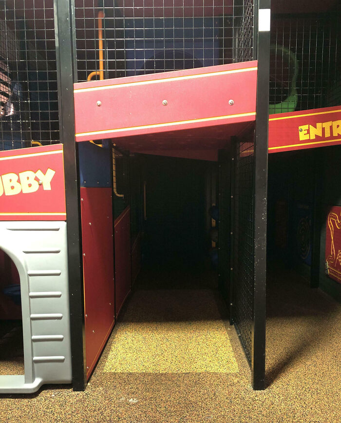 Dimly lit play area tunnel with dark shadows creating a creepy atmosphere people had to share with others.