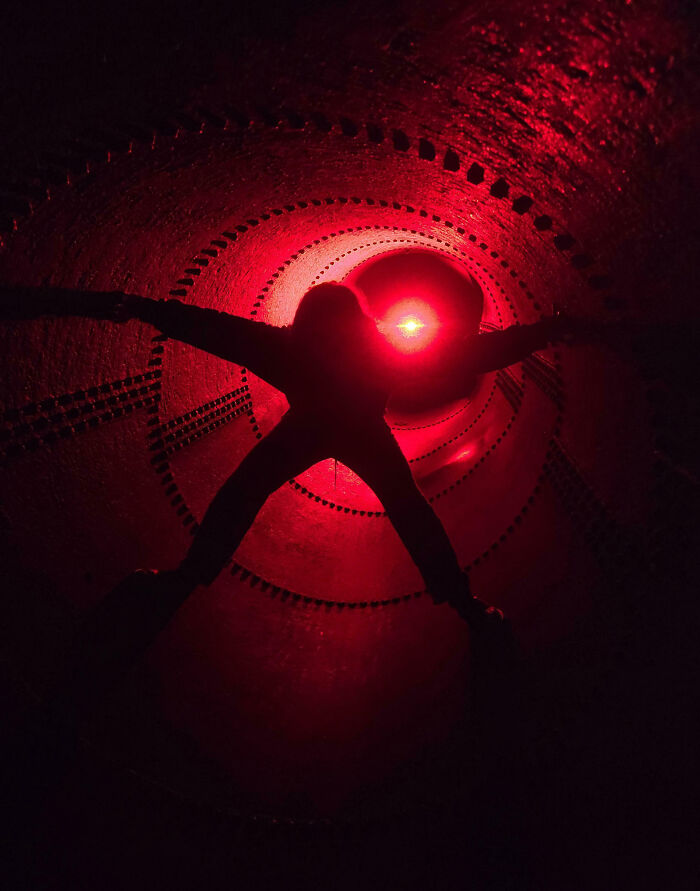 Silhouette of a person inside a red-lit tunnel, capturing a creepy scene that people felt compelled to share.
