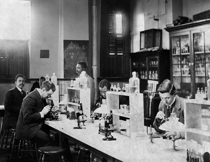 Early 1900s African American men working with microscopes in a laboratory, showcasing life at the Paris Exposition.