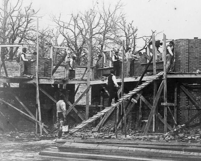 African American men working on brick construction at the 1900 Paris Exposition, showcasing life and labor.