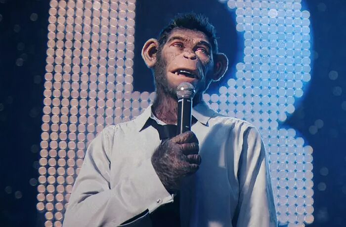 A realistic ape character in a white shirt holding a microphone, highlighting questionable movie details mocked online.