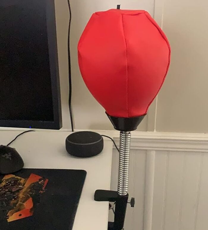 Red desktop punching bag attached to desk, perfect for making your desk a Monday happy place with fun finds.