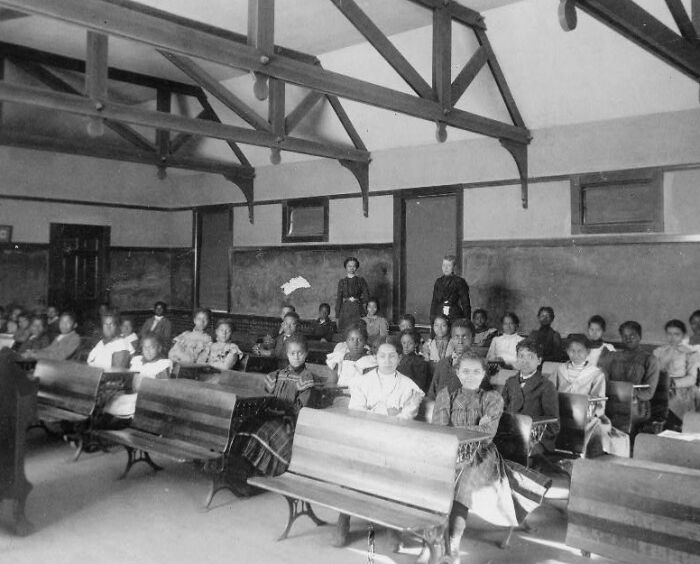 African American students seated in a classroom with teachers, capturing African American life at the 1900 Paris Exposition.