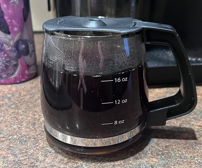 Coffee pot filled with black coffee on a countertop, representing hacks to become a morning person and start the day energized.