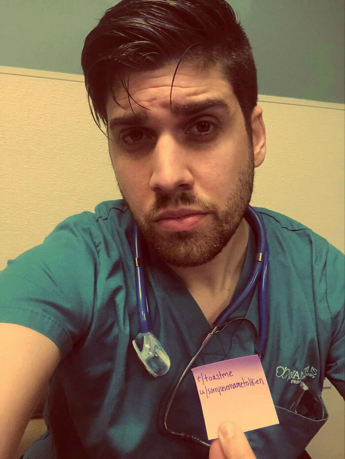 Young man in scrubs holding a note for internet toasts, part of people who asked for and received nice comments online.