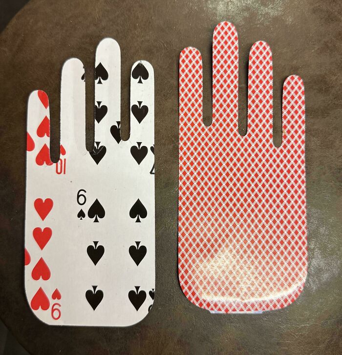 Playing cards cleverly cut into hand shapes to creatively solve overlooked design issues in daily objects.