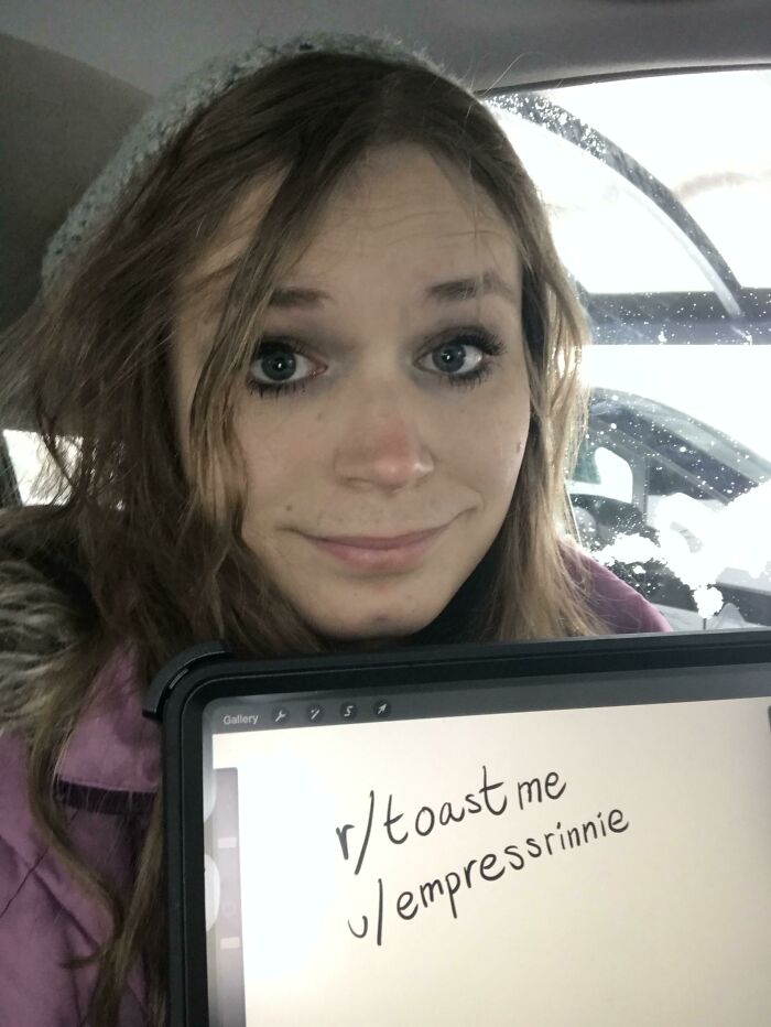 Young woman holding a tablet showing a toast request on Reddit, part of people who asked the internet for toasts.