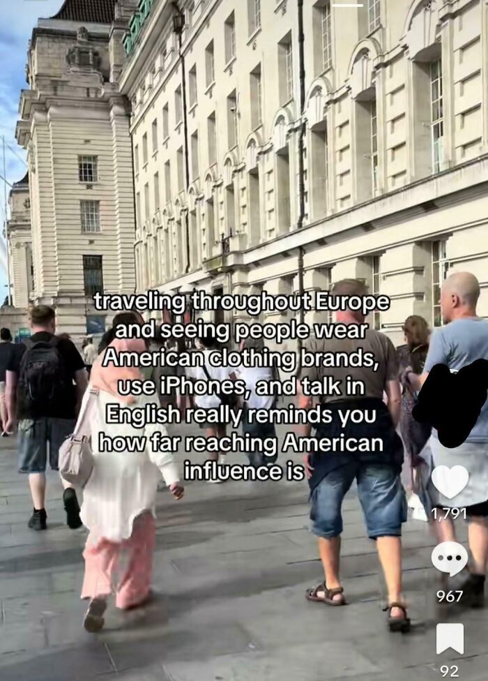 People walking on a city street with text about American influence highlighting ignorance of Americans in a European setting.