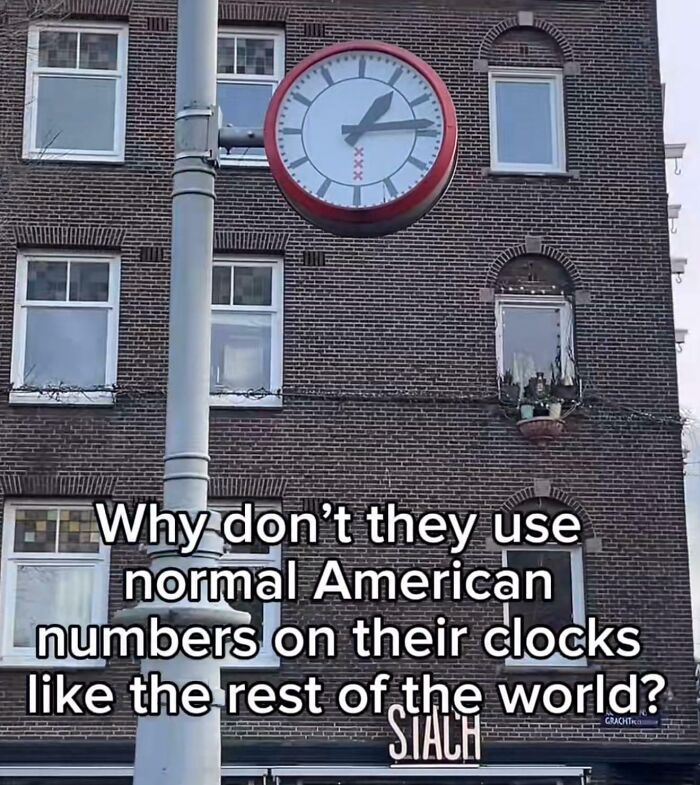 Clock on brick building with text questioning American ignorance about using normal numbers on clocks.
