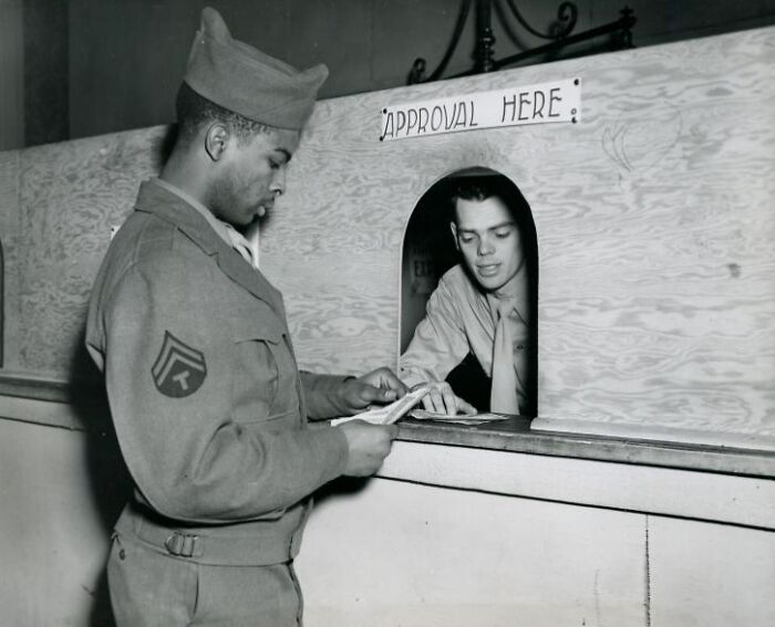 African American soldier in uniform receiving approval at a military checkpoint during historical service.