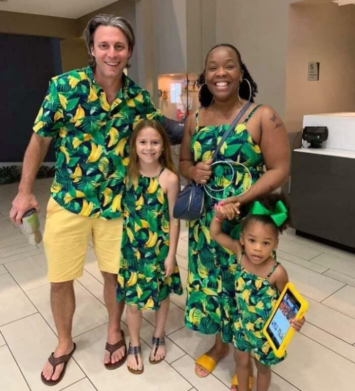 Family of four wearing matching banana print outfits, smiling together in a casual indoor setting, illustrating one-in-a-million coincidences.