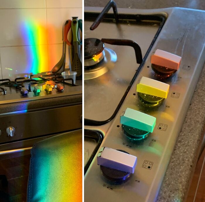Rainbow light casts perfectly aligned colors on stove knobs, illustrating one-in-a-million coincidences in everyday life.