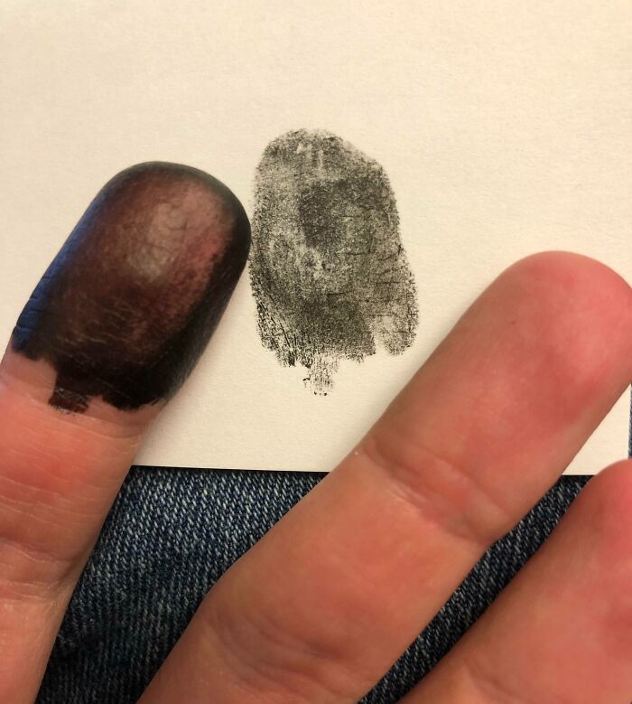 Fingerprint inked on finger next to a matching fingerprint mark on paper illustrating one-in-a-million coincidences concept.