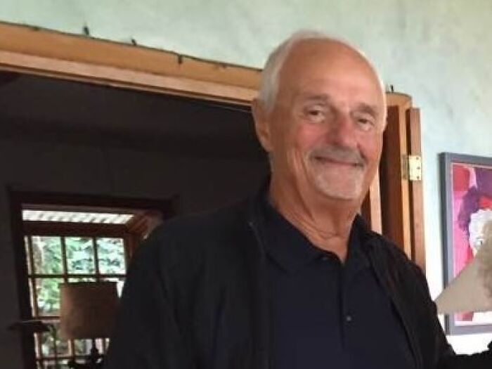 Elderly man smiling indoors, representing notable people who passed away in 2025 for tribute and remembrance.