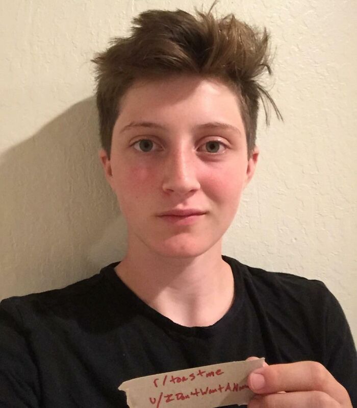 Person with short hair holding a toast sign, sharing a moment from 80 people who asked the internet to toast them.