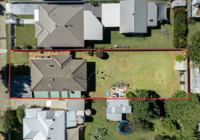 Aerial view of a residential property with poorly maintained yard highlighted, illustrating bad landlords in renting situations.