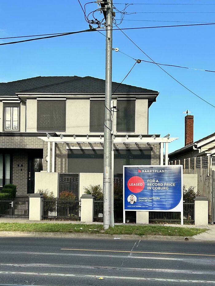 Modern rental house with leased sign outside, highlighting issues faced with bad landlords in rental properties.