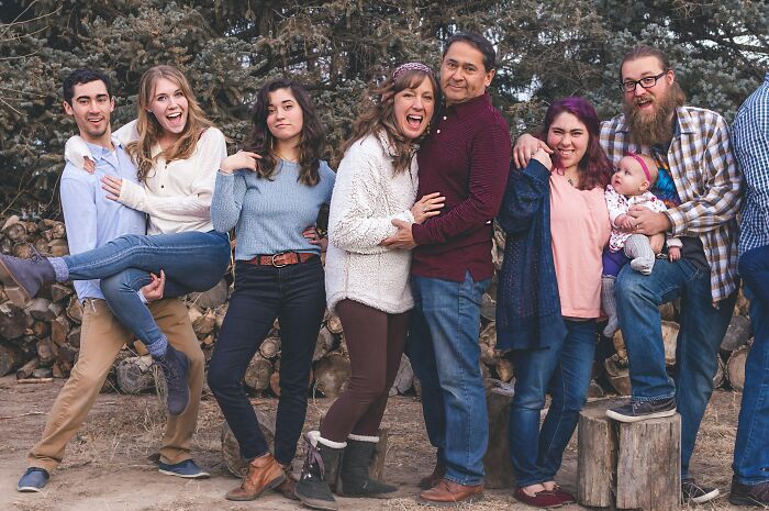Group of seven diverse people outdoors smiling and posing together, illustrating harshest life gives you lemons advice.