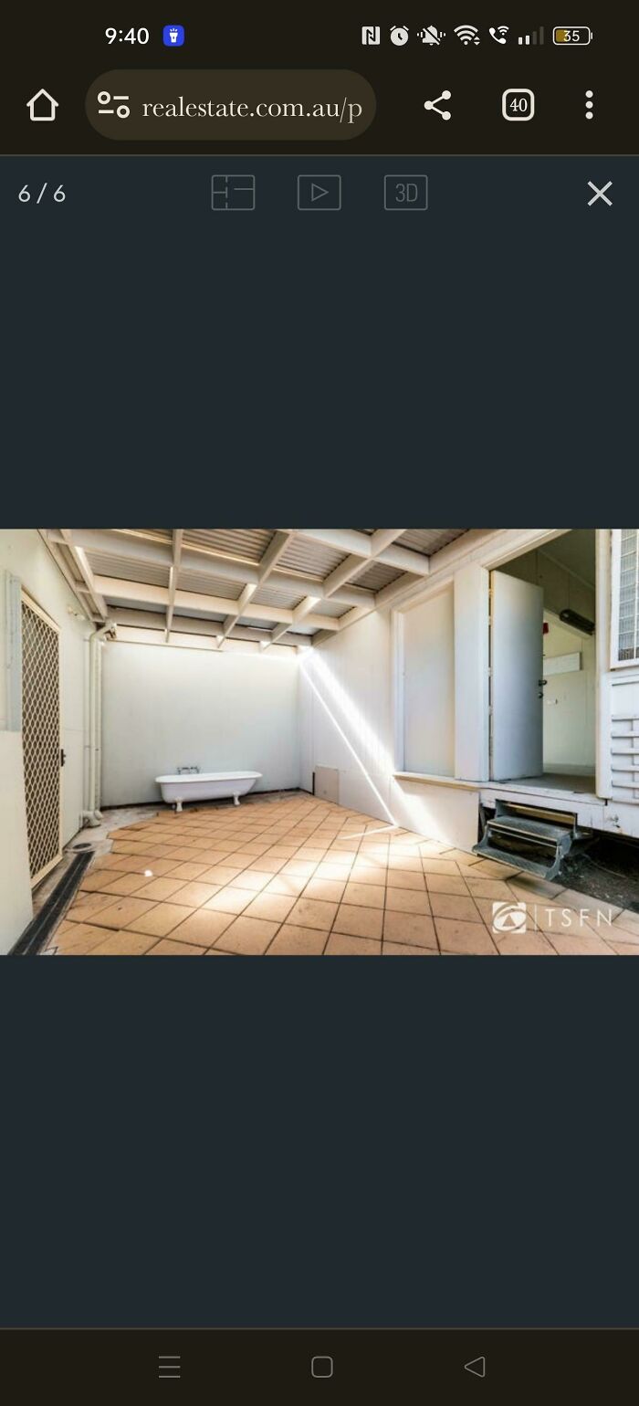 Outdoor tiled patio with a bathtub against the wall, open door to interior, illustrating bad landlords renting issues.