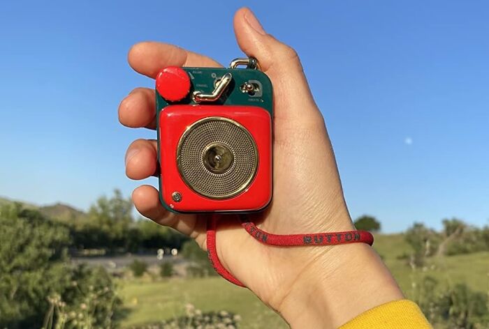 Hand holding a vintage red and green gadget outdoors with clear sky, illustrating Amazon rabbit hole hidden gems discovery.