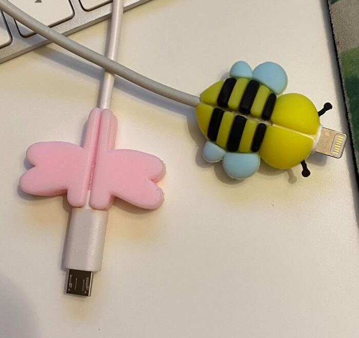 Cable protectors shaped like a pink butterfly and a yellow bee on charging cables, Amazon hidden gems accessory.