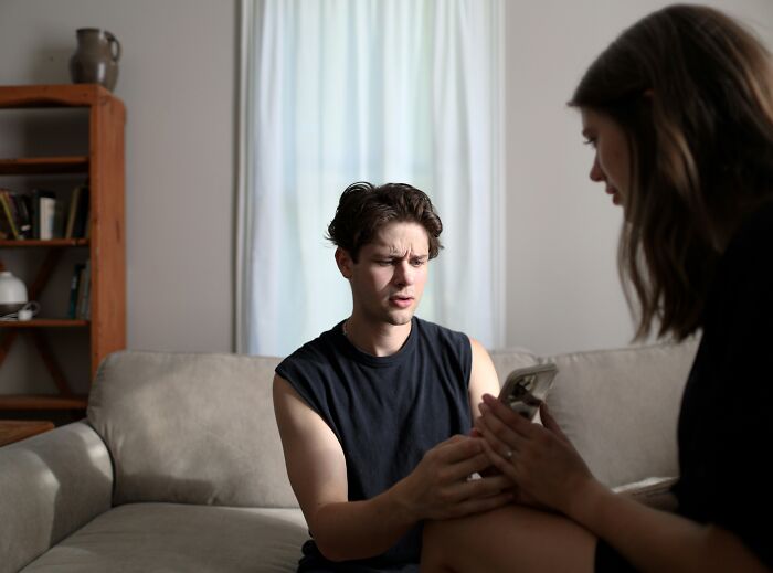Two people having a serious conversation on a couch, illustrating harsh when life gives you lemons advice.