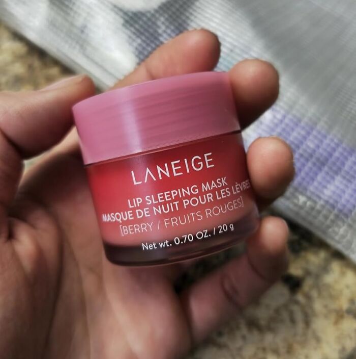 Laneige berry lip sleeping mask held in hand, one of the popular TikTok finds from the For You page.