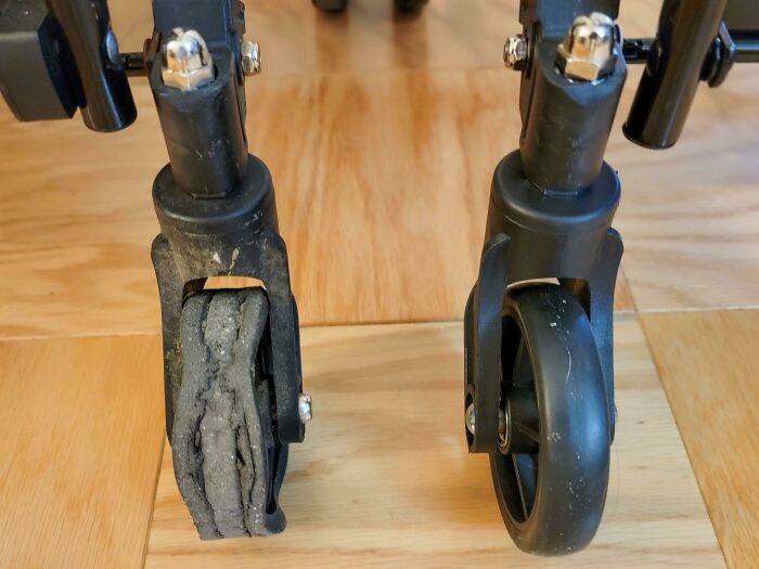 Before and after photo showing a worn-out caster wheel next to a new replacement wheel on a wooden floor.