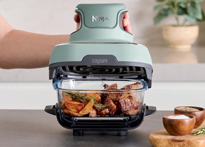 Compact Ninja air fryer with crispy roasted meat and potatoes, a popular TikTok find from the For You page trends.