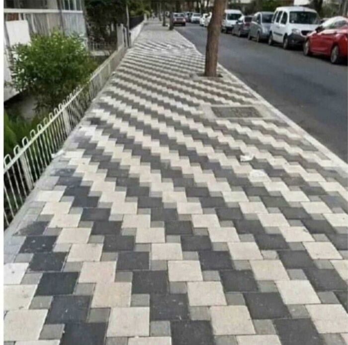 Sidewalk with dangerous design pattern creating an optical illusion, representing one of the most hazardous death traps.